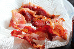 Crispy cooked bacon draining on paper towel