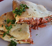 Sliced bbq chicken calzone filling inside