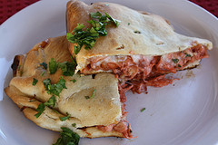 Sliced bbq chicken calzone filling inside