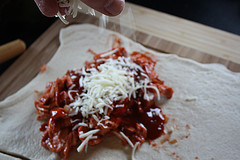 Shredded cheese and bbq chicken on dough
