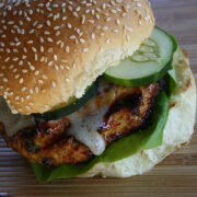 Close up of grilled chicken burger with cucumber