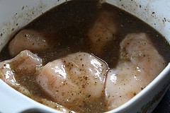 Chicken marinating in seasoned liquid