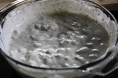 Creamy tzatziki sauce in glass bowl