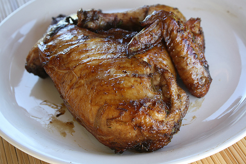 Close up of grilled jerk chicken quarter