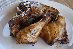 Glazed jerk chicken pieces on plate