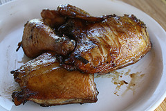 Grilled jerk chicken quarters on white plate