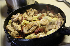 Mushrooms and bacon cooking in skillet