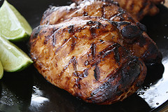 Grilled chicken breast with lime wedges