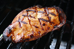 Grilled chicken breast on grill grates