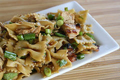 Sesame chicken pasta salad on white platter