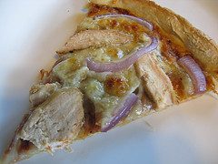 BBQ chicken pizza slice with red onion