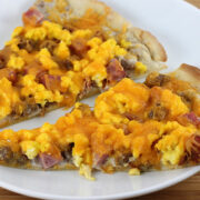 Breakfast pizza slices on white plate