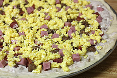 Breakfast pizza with eggs and sausage