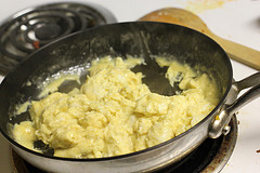 Scrambled eggs cooking in skillet