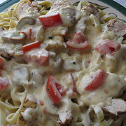 Chicken alfredo over fettuccine pasta