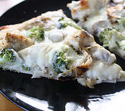 Chicken alfredo pizza slices with broccoli