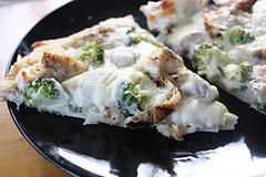 Chicken alfredo pizza slices with broccoli