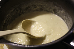 Creamy alfredo sauce cooking in pot