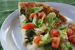 Chicken caesar pizza with lettuce and tomato
