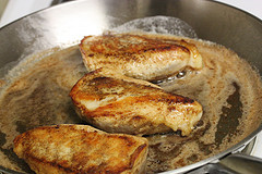 Chicken breasts cooking in pan