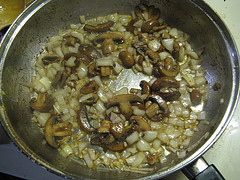 Mushrooms and onions cooking in skillet
