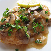 Chicken piccata with parsley garnish
