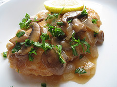 Chicken piccata with parsley garnish
