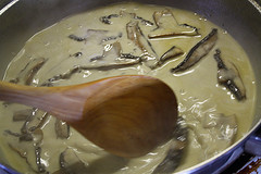 Creamy mushroom sauce cooking in skillet