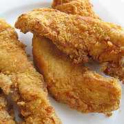 Crispy fried chicken strips on plate