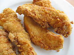 Crispy fried chicken strips on plate