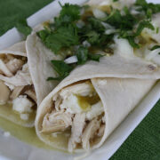 Close up chicken enchiladas verdes with cheese