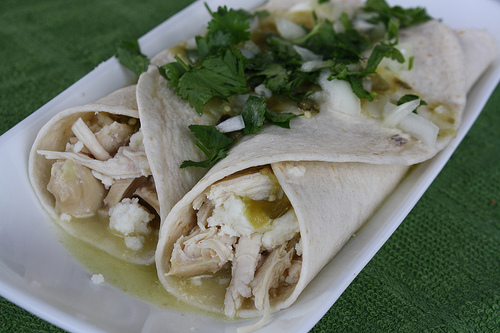 Close up chicken enchiladas verdes with cheese