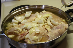 Chicken and potatoes boiling in broth
