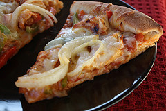 Fajita pizza slices on black plate