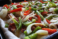Sliced onions and bell peppers for fajita pizza