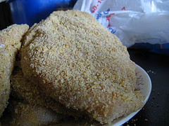 Breaded chicken breasts before cooking