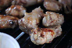 Chicken wings grilling over heat