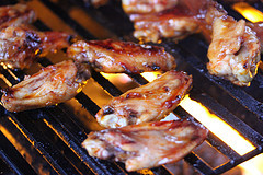 Chicken wings cooking on grill grates