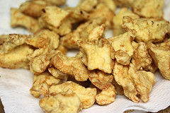 Fried chicken pieces draining on paper towel