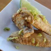 Lime chicken wings with lime wedge