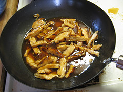 Chicken strips cooking in sauce
