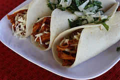Mexican shredded chicken tacos with cilantro and onion