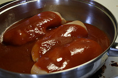 Chicken breasts simmering in tomato sauce
