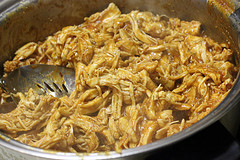 Shredded chicken cooking in sauce