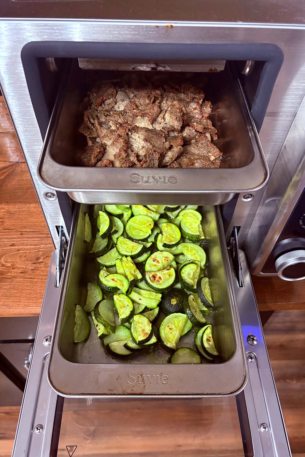 Two trays of food cooking in the Suvie oven 