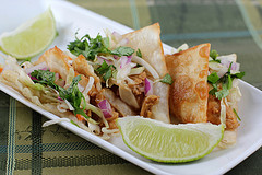 Wonton tacos with lime wedges