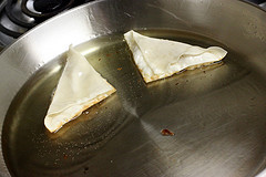 Wonton shells frying in pan